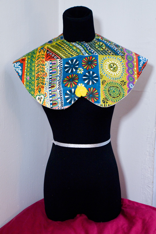 a multi pattern patchwork bib on a black mannequin