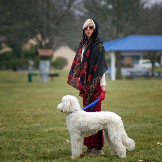 sammy davis wears a 1970s vintage dress from emotional outlet vintage with her goldendoodle mac